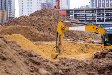 Heavy machinery for excavation and landscaping. Close-up view of an excavator at a construction site. The excavator excavates the soil for excavation and construction.の写真素材