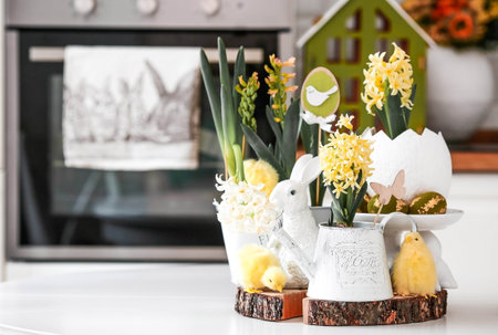 Spring yellow hyacinth flowers in an egg-shaped vase, chickens on a white table. Easter decor in the house. The concept of happy Easter.の写真素材