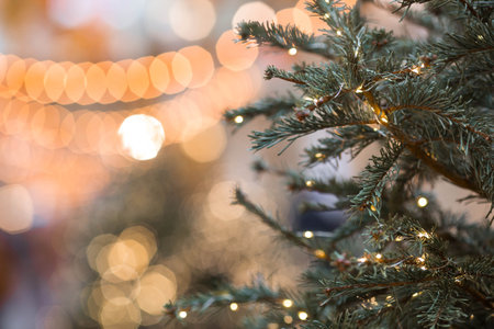 New Year's card 2026. Festive garlands and lights on the Christmas tree. Close-up. Beautiful Christmas background. The concept of decorations and decorations for the new year.の写真素材