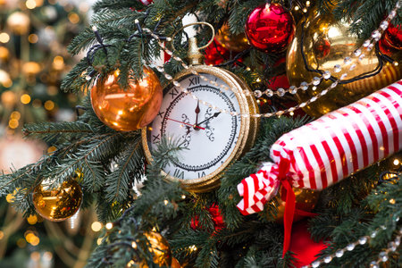 The hands of the clock show 12 o'clock at night. The clock on the Christmas tree shows the New Year. Beautiful background for New Year or Christmas 2026.の写真素材