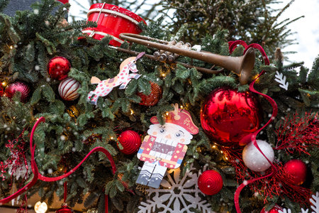 Festive toys and a nutcracker on a Christmas tree in Moscow. New Year's card 2026. Beautiful...