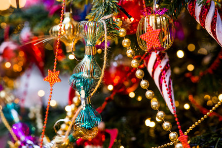 Festive toys on the Christmas tree. New Year's card. Beautiful Christmas background. The concept of preparing decorations and decorations for the new year.の写真素材