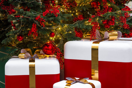 Fabulous Christmas background. Festive toys and gift boxes on the New Year tree in Moscow. The...