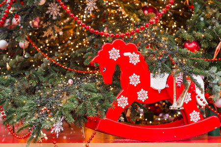 Close-up. Beautiful red horse on a Christmas tree. Beautiful Christmas background. Concept of preparing for the New Year. New Year's card 2026.の写真素材