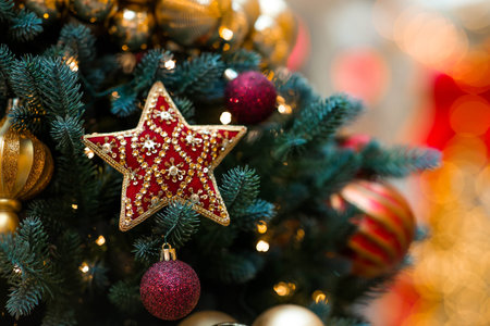 Beautiful Christmas background. Holiday toys on the Christmas tree. Concept of preparing decorations and furnishings for the New Year. New Year's card 2026.の写真素材