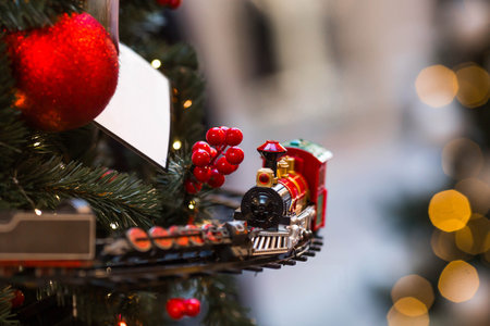 Christmas train on the Christmas tree. New Year's card 2026. Beautiful Christmas background with a train. Concept of preparing decorations and outfits for the New Year.の写真素材