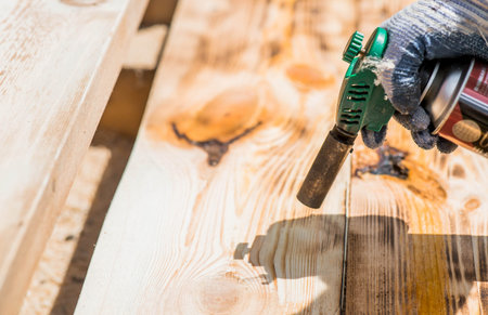 The process of burning wooden boards with a burner. The texture of wood treated with fire from a...