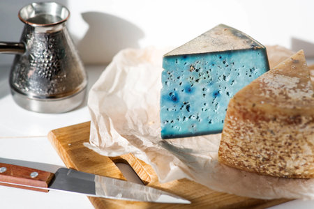 A piece of blue, fresh, aged, natural farm cheese with lavender on a wooden board. Unusual taste and quality of farm-fresh agricultural products.の写真素材