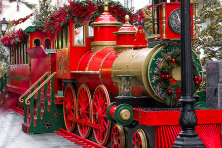 Atmospheric Christmas background. Christmas train on the street in Moscow. New Year's card 2026. Concept of preparing decorations and outfits for the New Year.の写真素材
