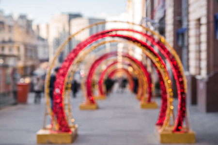 Blurry holiday background. Christmas street decorations, glowing arch and lights, beautiful bokeh.の写真素材