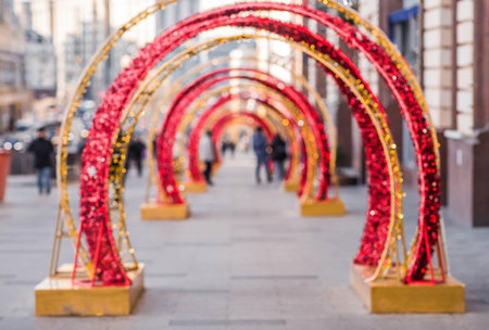 Blurry holiday background. Christmas street decorations, glowing arch and lights, beautiful bokeh.の写真素材