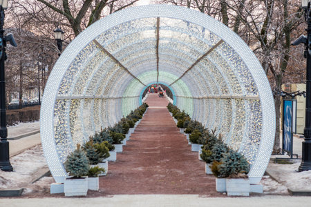 Blurry holiday background. Christmas street decorations, glowing arch and lights, beautiful bokeh.の写真素材