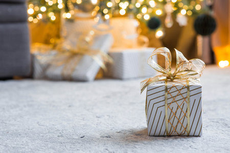 A cozy concept for the Christmas holidays of 2026. Stylish gift boxes, toys, and a Christmas tree in...