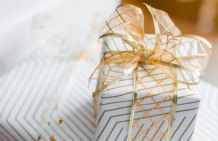 New Year's Eve, cozy concept for the Christmas holidays Stylish gift boxes on the background of a Christmas tree in the home interior of the living room. We are preparing gifts for our loved ones.の写真素材