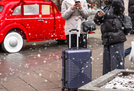 The new year is 2025. Tourists girls with a suitcase in the center of Moscow. Tourism in Russia for the New Year holidays. New Year decorations in Moscow. Christmas holidays. Russia, Moscow, 26 December 2024の写真素材