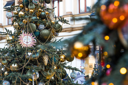 Holiday toys on the Christmas tree. Beautiful Christmas background. Concept of preparing decorations...