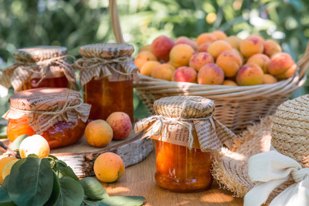 Sweets and fruits. Homemade healthy jelly, apricot jam. Preserving and harvesting in the summer. Preparing jars.の写真素材