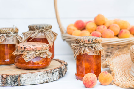 Sweets and fruits. Homemade healthy jelly, apricot jam. Preserving and harvesting in the summer. Preparing jars.の写真素材