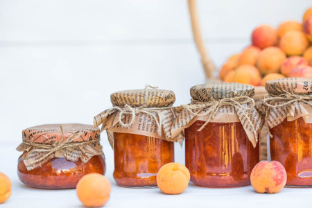 Sweets and fruits. Homemade healthy jelly, apricot jam. Preserving and harvesting in the summer. Preparing jars.の写真素材