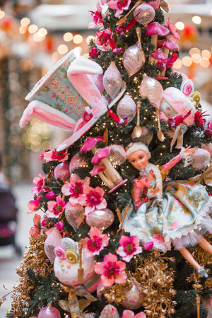 Pink holiday decorations on the Christmas tree. Close-up. Beautiful Christmas background. Concept of decorations and decor for the new year.の写真素材