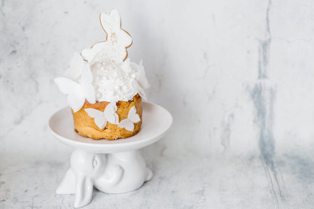 Happy Easter 2026. Stylish Easter still life. Easter cake with a white rabbit and airy rice paper...