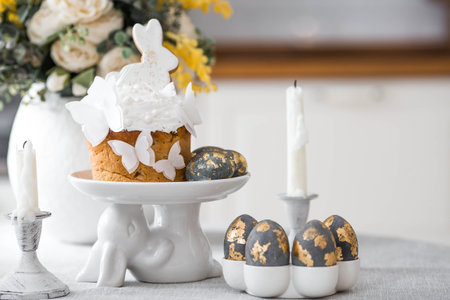 Easter food. Happy Easter 2026. Easter cake with white gingerbread bunnies, rice paper butterflies,...