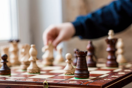 Playing chess. Wooden chess pieces on the board. Game strategy. Knight move.の写真素材