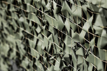 A camouflage net with green ribbons attached to the net. Camouflage during combat operations. Texture. Banner.の写真素材