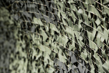 A camouflage net with green ribbons attached to the net. Texture. Banner.の写真素材