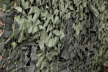 A camouflage net with green ribbons attached to the net. Texture. Banner.の写真素材