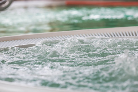 Banner. A round jacuzzi with bubbling hot thermal water and a metal staircase. A concept of...