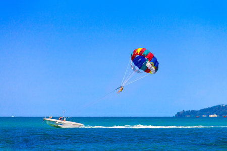 Parasailing is a popular pastime in many resorts around the world. The active form of relaxation. Focus on a parachute. の写真素材