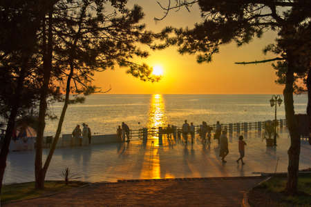 Quay of the resort town is illuminated by the setting sun. の写真素材