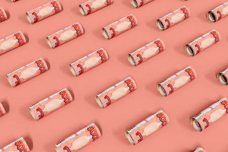 Rolled up ruble bills lie on a pink surface. Creative money pattern. The banknotes are arranged diagonally. 3d illustration.の写真素材