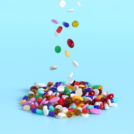 Different tablets and pills falling from above in a heap on a blue background. Production of drugs. Medical theme. 3d rendering.の写真素材