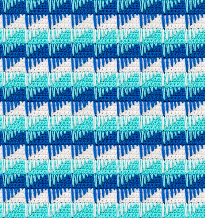 Seamless knitted texture. The pattern in the form of icicles is crocheted with multi-colored...