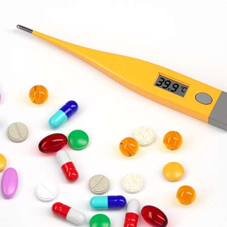Digital thermometer with a high temperature marker and various tablets and pills lie on the table....