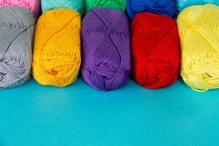 Colorful multicolored background from skeins of cotton yarn. materials for knitting. textile...