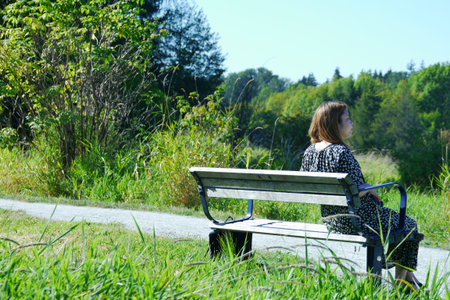 Japanese woman sitting on bench enjoying view