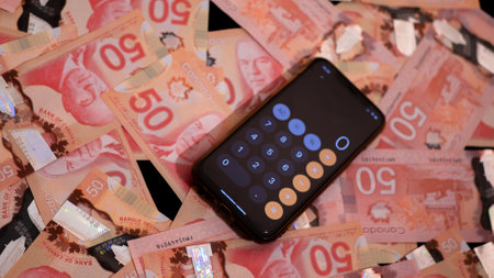Lots of Canadian dollars and calculatorsの写真素材