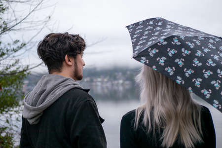 Couple sticking together on bridge and enjoying the viewの写真素材