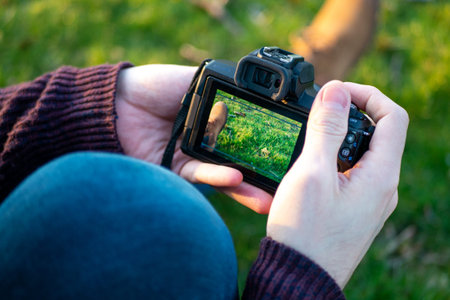 Man's hand touching camera