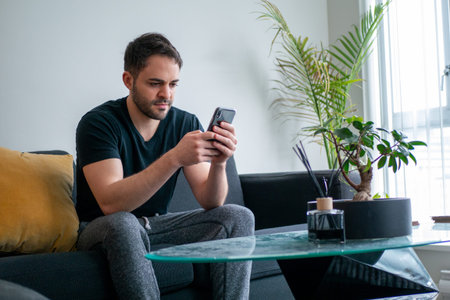 Western man sitting on sofa in room