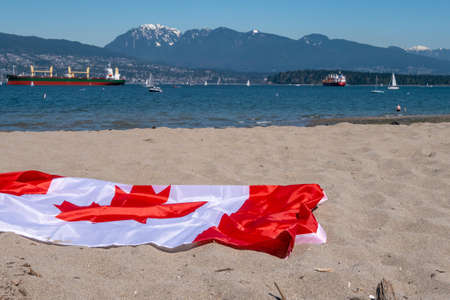 Large Canadian flag on sandy beachの写真素材