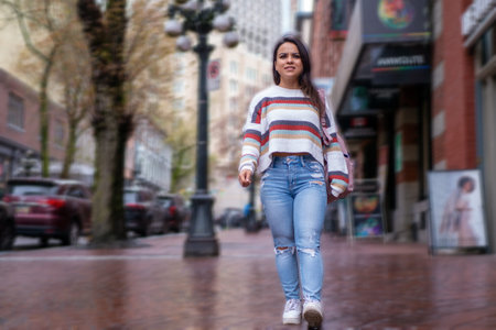 Mexican woman sightseeing in downtown Vancouver in the rain