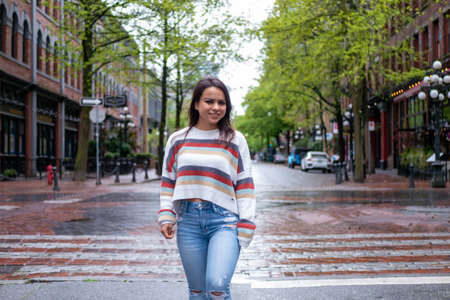 Mexican woman sightseeing in downtown Vancouver in the rainの写真素材