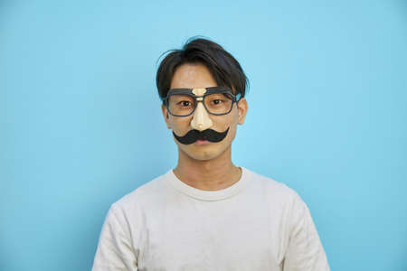 Asian man wearing beard glasses of party goodsの写真素材