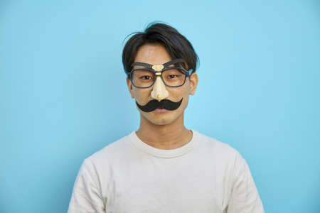 Asian man wearing beard glasses of party goodsの写真素材
