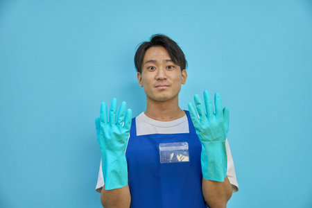 Asian man cleaning in rubber gloves