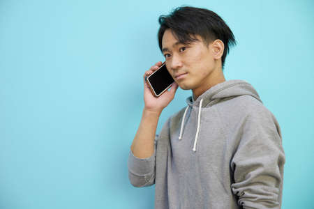 Asian man making phone callsの写真素材